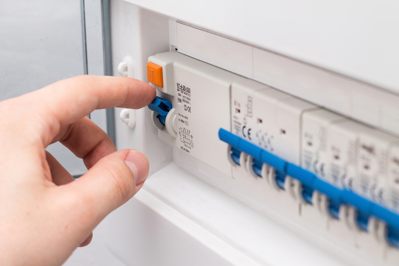 man turning on the fuse box